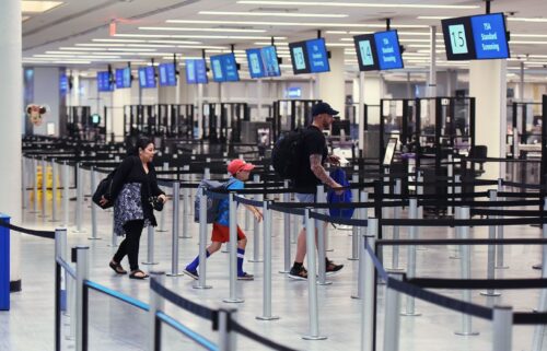 A family rushes to a TSA screening checkpoint at Orlando International Airport. The Department of Homeland Security announced an expansion of Transportation Security Administration checkpoints for families traveling with children and military members on July 17.