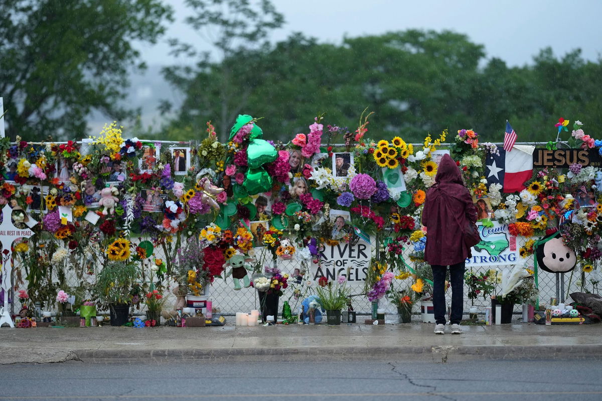 <i>Eric Gay/AP via CNN Newsource</i><br/>A visitor views a memorial wall for flood victims