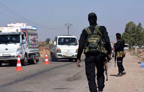 Syrian government security forces man a checkpoint along a road in southern Syria's Suwayda province.