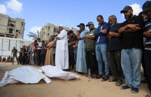 Palestinians recite a prayer over a body at the Nasser hospital on July 19.