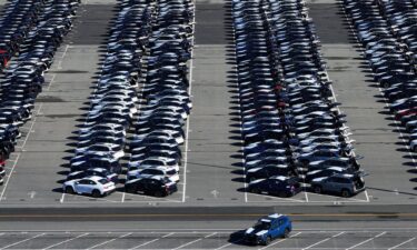 Brand new Subaru cars sit in a storage lot on March 24