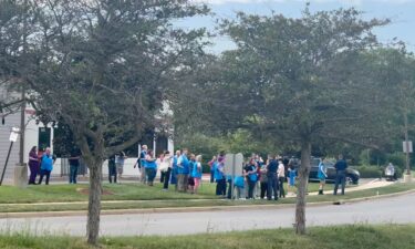 Police officers speak to Walmart employees outside a Walmart store