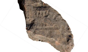 A fragment of roof tile decorated with what appears to be a menorah.