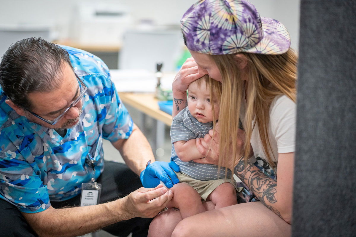<i>Jan Sonnenmair/Getty Images via CNN Newsource</i><br/>Raynard Covarrubio administers an MMR vaccine at a vaccine clinic in Lubbock