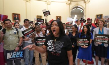 Rep. Jasmine Crockett protests redistricting plans before the hearing of the House Select Committee on Congressional Redistricting at the Capitol in Austin