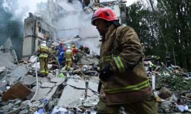 Rescue workers carry out a search and rescue operation at a destroyed residential building struck in a Russian drone-and-missile attack on July 31 in Kyiv