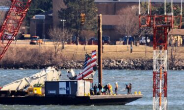 A crane recovers the tail of American Airlines flight 5342 near Ronald Reagan Washington National Airport on February 4.