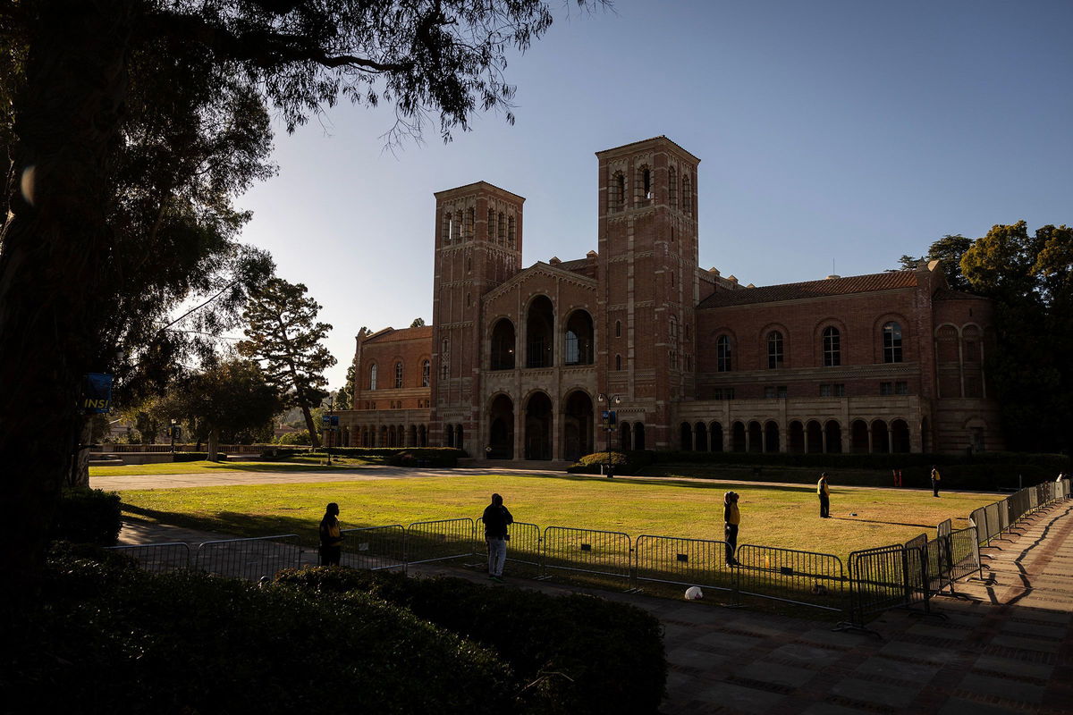 <i>Eitienne Laurent/AFP/Getty Images/File via CNN Newsource</i><br/>Security officers stand guard on the lawn in front of UCLA's Royce Hall in May 2024. UCLA is the latest major institution of higher learning to see promised research funding snatched away by the Trump administration.