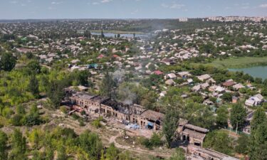 Rescuers from the Emergency Services of Ukraine extinguish a blaze in the aftermath of a Russian drone strike on a warehouse storing food products in Sloviansk
