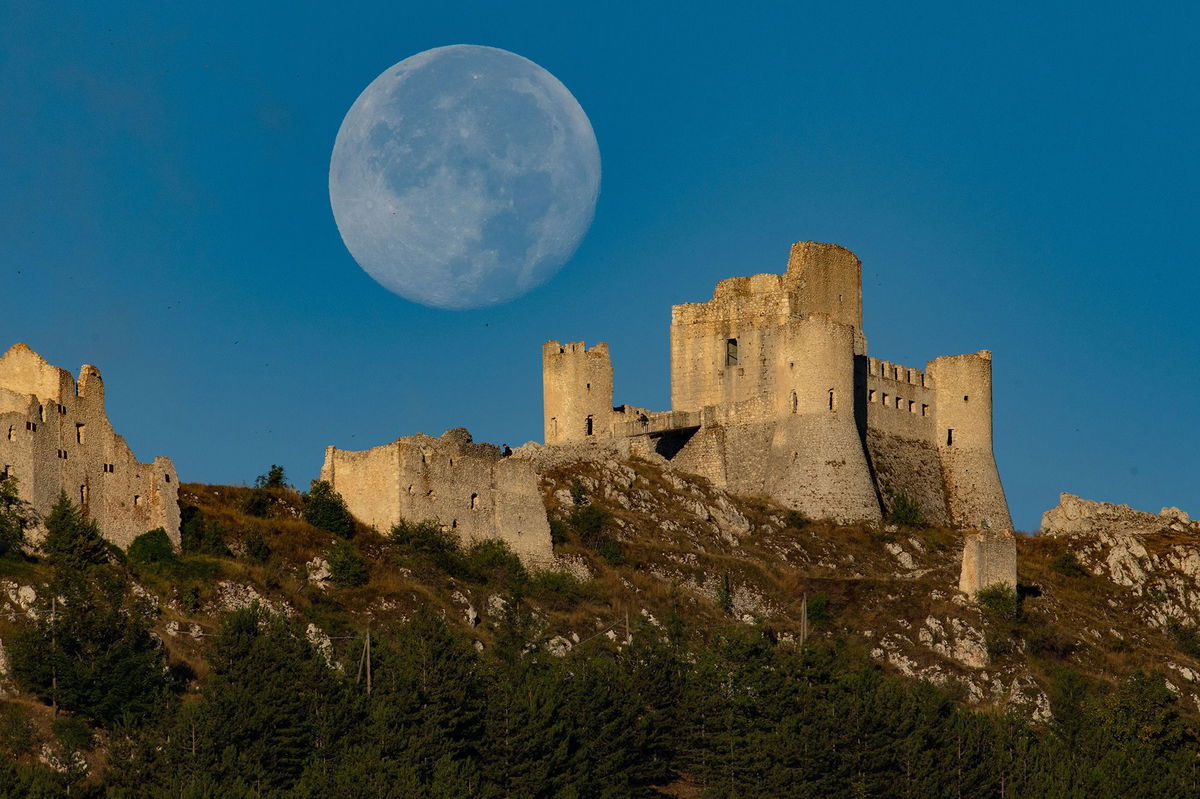 <i>Lorenzo Di Cola/NurPhoto/Shutterstock via CNN Newsource</i><br/>The full sturgeon moon appears in the sky over Rocca Calascio Castle in Calascio