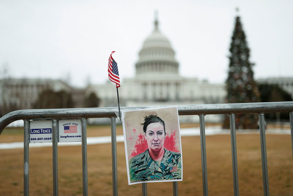 <i>Tom Brenner/Reuters/File via CNN Newsource</i><br/>A poster of Ashli Babbitt