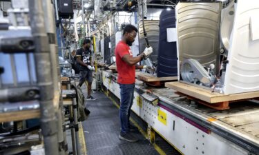 Workers are seen on the production line at GE Appliances on August 13 in Louisville