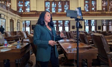 State Rep. Nicole Collier talks on the phone from the floor of the House