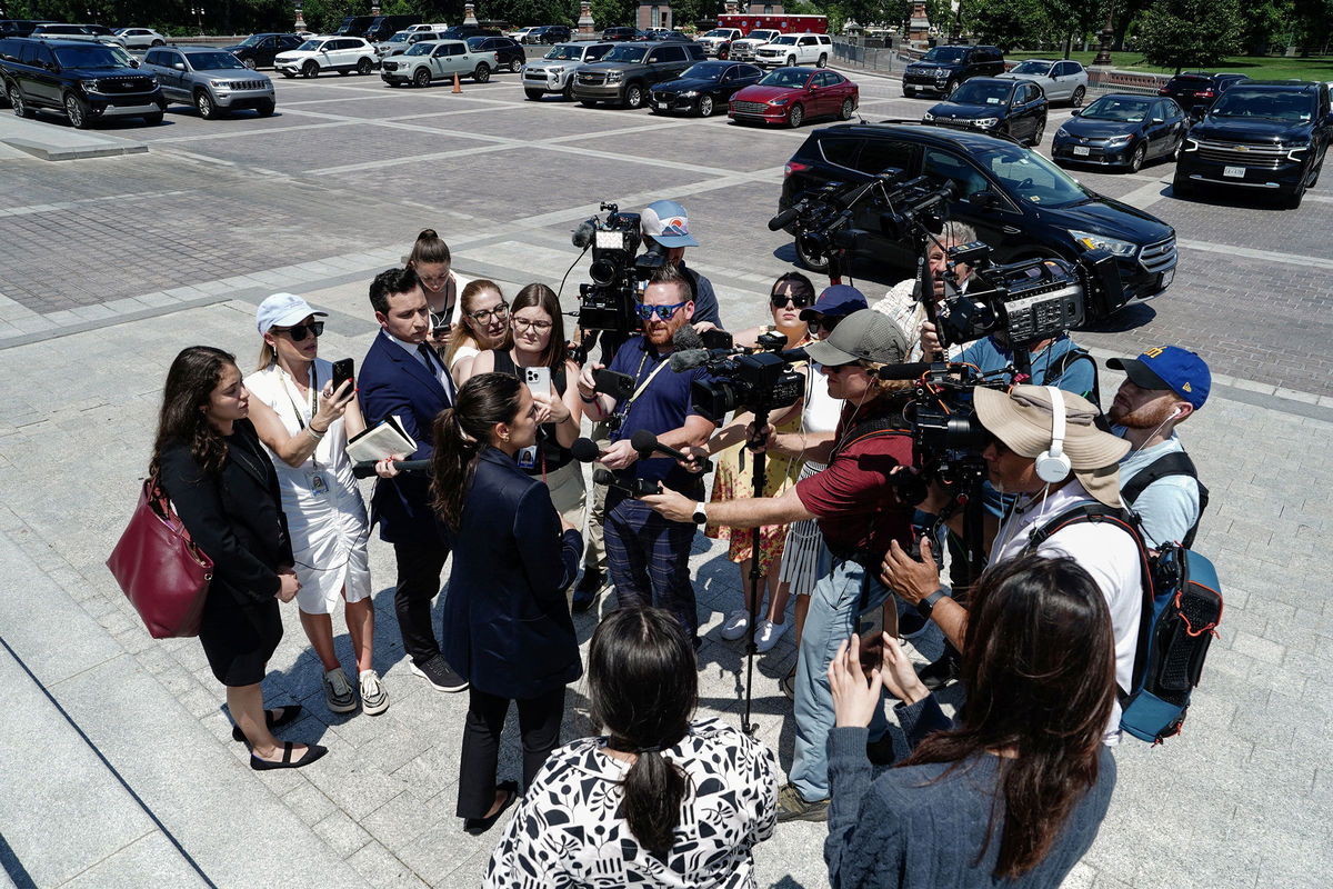 <i>Ken Cedeno/Reuters via CNN Newsource</i><br/>Rep. Alexandria Ocasio-Cortez speaks to the media after the House of Representatives voted to pass President Donald Trump's spending and tax bill