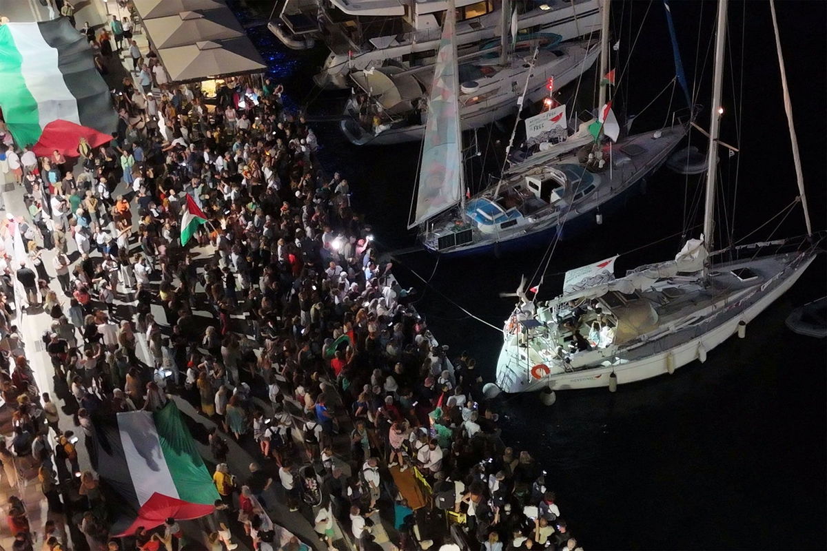 <i>Giorgos Solaris/Reuters via CNN Newsource</i><br/>A screenshot from a drone video shows people gathering at a Greek port before the departure of two boats taking part in the Global Sumud Flotilla on September 14.