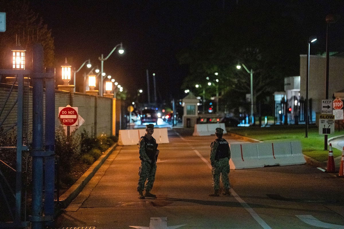 <i>Kent Nishimura/Getty Images via CNN Newsource</i><br/>Guards stand at the gate