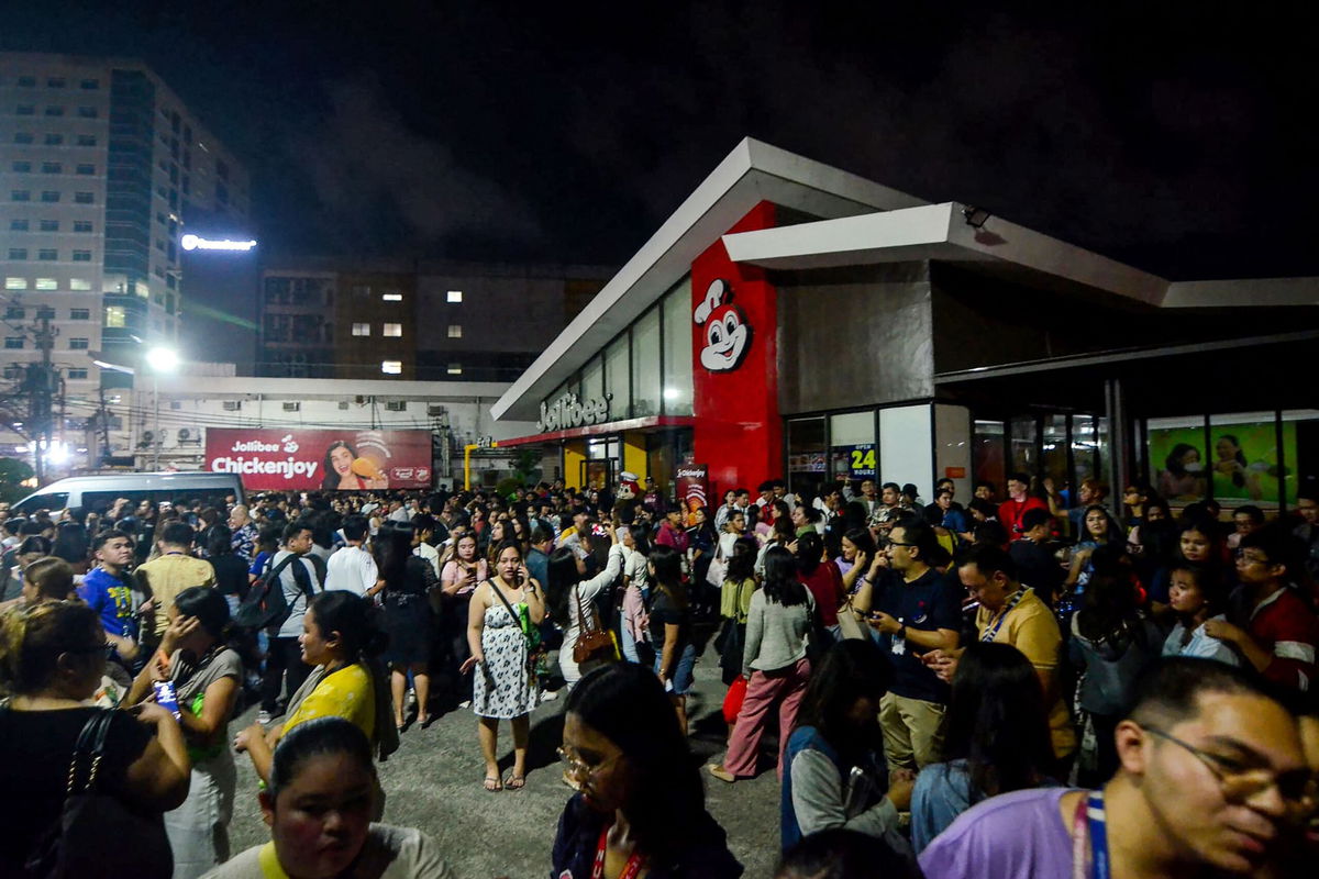 <i>Alan Tangcawan/AFP/Getty Images via CNN Newsource</i><br/>People gather on a street after earthquake tremors at Cebu in central Philippines on September 30.