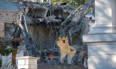 Workers demolish the facade of the East Wing of the White House on Monday