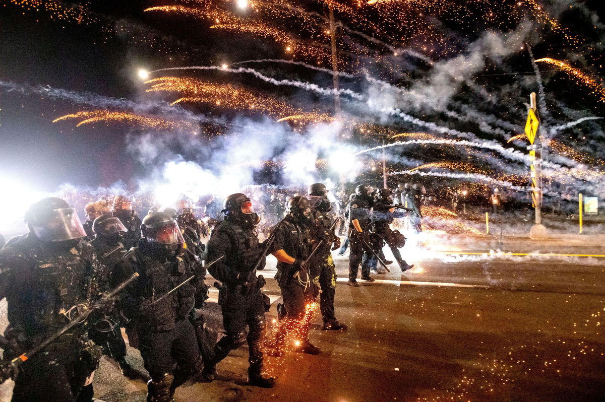 <i>Noah Berger/AP via CNN Newsource</i><br/>Police use chemical irritants and crowd control munitions to disperse protesters September 5 in Portland.