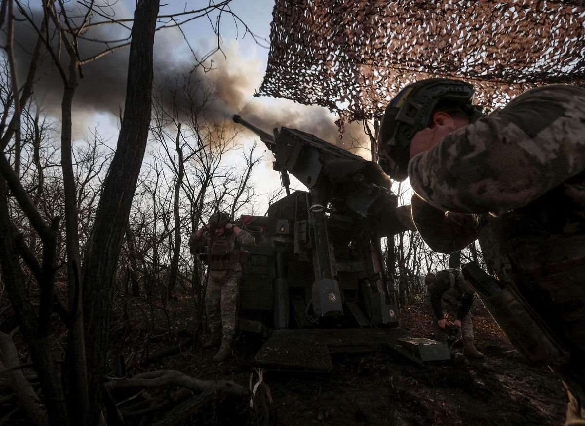 A Ukrainian soldier fires towards Russian troops at a position on the front line near Pokrovsk